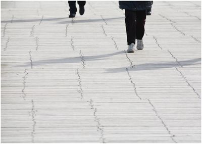 Low section of people walking on footpath