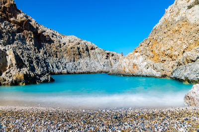 Scenic view of lake against clear blue sky