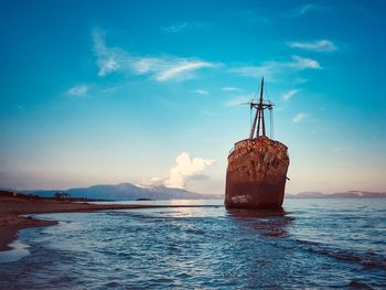 Sailboat on sea against blue sky