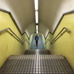 Rear view of man on staircase