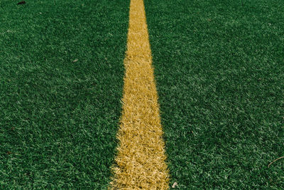 Close-up of yellow yard line on soccer field