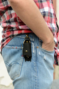 Midsection of man holding camera