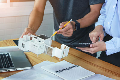 Midsection of man working on table