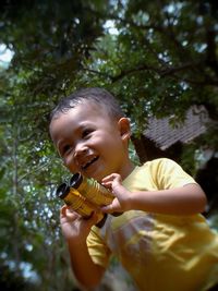 Portrait of smiling boy holding girl