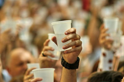 Close-up of hand holding coffee cup