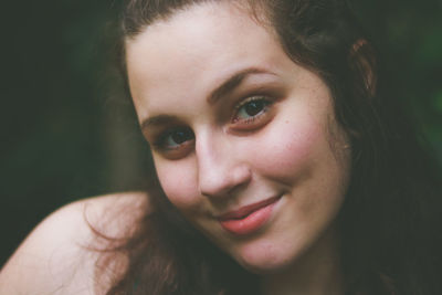 Close-up portrait of smiling teenage girl at park