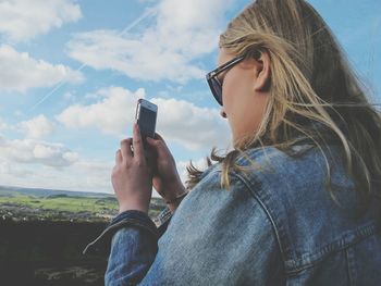 Portrait of woman standing against sky