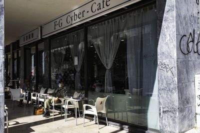 Chairs and tables by window at restaurant