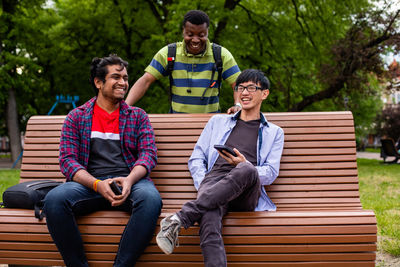 Young couple sitting on bench in park