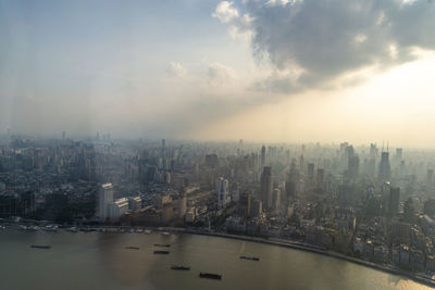 High angle view of buildings against cloudy sky