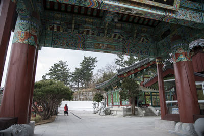 Man in front of built structure