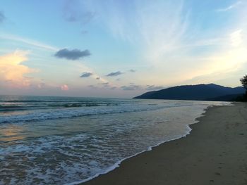 Scenic view of beach against sky during sunset