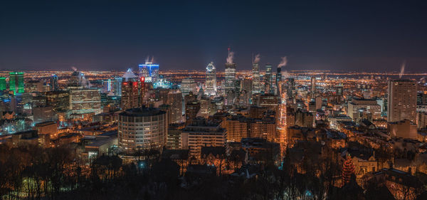 Aerial view of city lit up at night