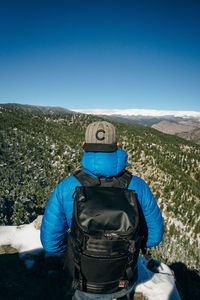 Rear view of man on snow against mountain