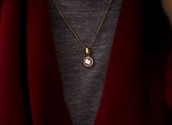 Midsection of woman wearing diamond pendant
