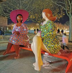 Rear view of people walking with umbrella