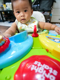 Portrait of cute boy with toy toys