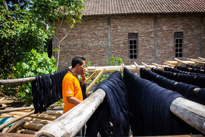  the craftsmen do  dyeing process of the fabric lurik in tringsing village,  java, indonesia