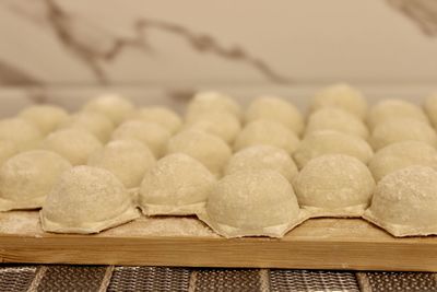 Dumplings made of dough and minced meat are stuck on the board