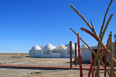 Built structure on beach against clear blue sky