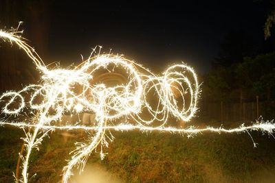 Light painting against sky at night