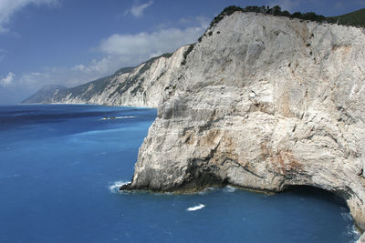 Scenic view of sea and mountains against sky