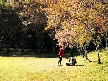 People walking on golf course in park