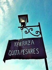 Low angle view of road sign against sky