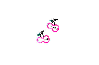 Toy riding bicycle on pink background