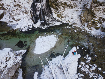 High angle view of woman on rock during winter