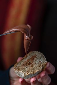 Close-up of hand holding ice cream