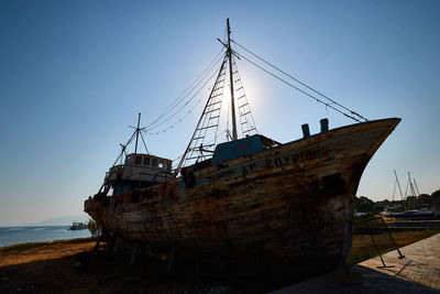 Ship moored on sea against clear sky