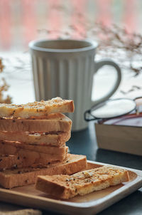 Garlic breadsticks in a wooden tray