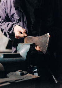 Midsection of man working on table