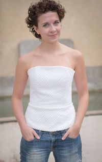 Portrait of beautiful woman standing against blurred background