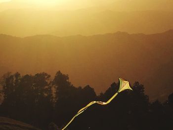 Scenic view of mountains against sky at sunset