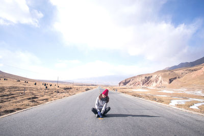 Rear view of man on road against sky