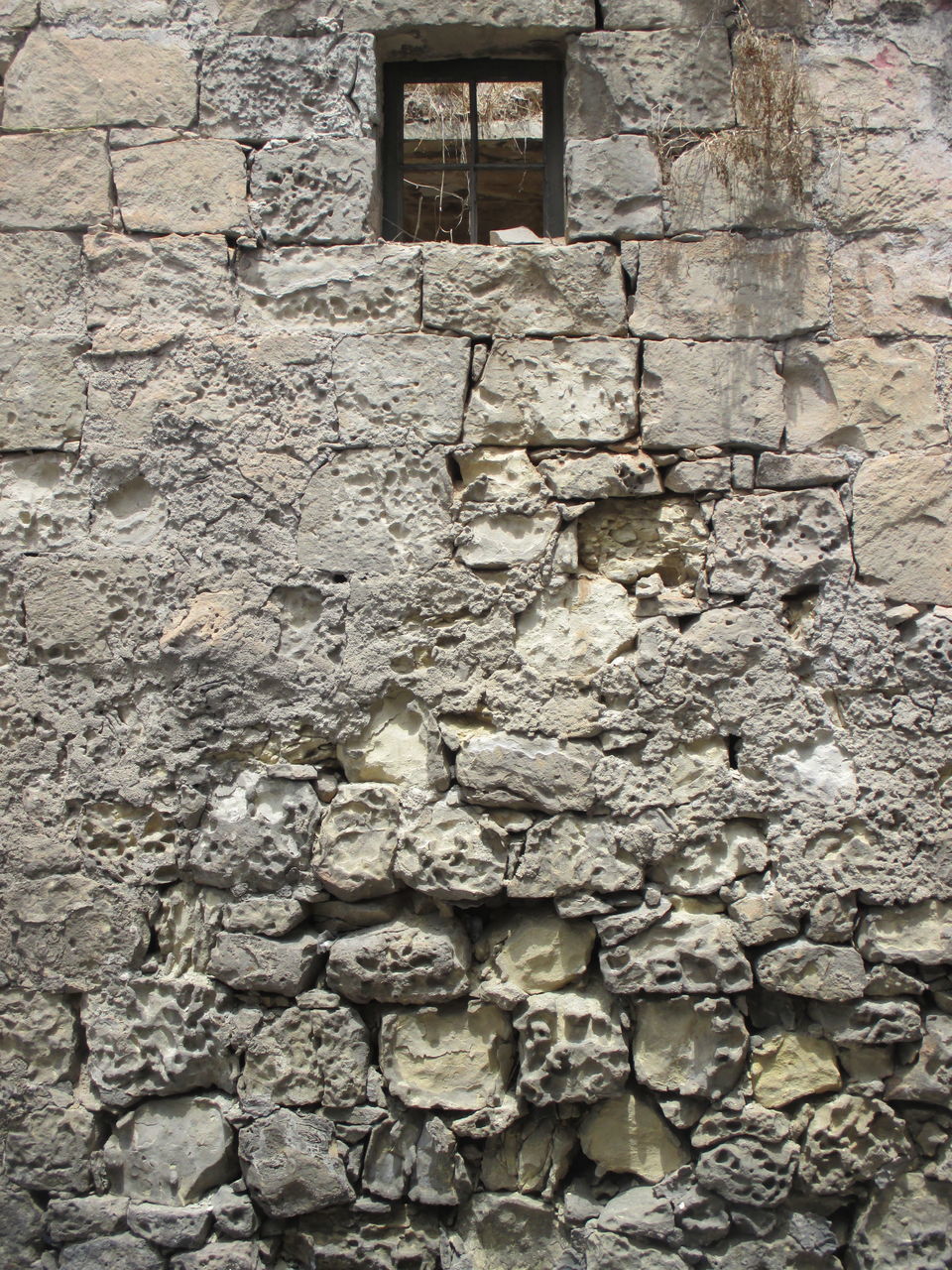 FULL FRAME SHOT OF STONE WALL WITH WINDOW