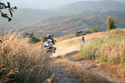 People riding motorcycle on land
