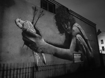 Low angle view of people on wall