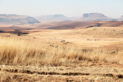 Scenic view of arid landscape against sky