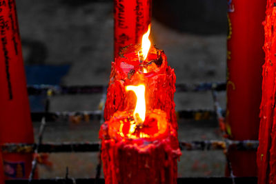 Close-up of lit candles in building