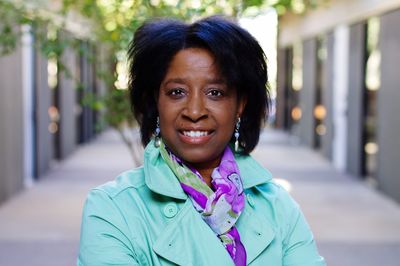 Portrait of smiling mature woman standing on walkway