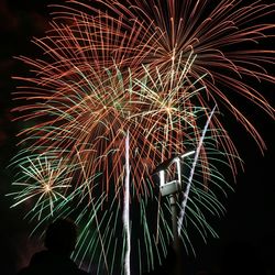 Low angle view of firework display at night