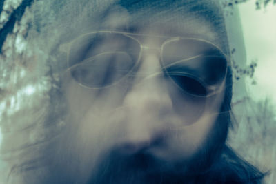 Close-up portrait of man wearing sunglasses