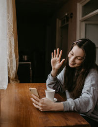 Young woman sitting on table