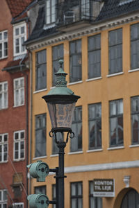 Low angle view of street light against building