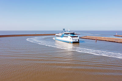 Ferry boat arriving in the harbor from harlingen in friesland the netherlands