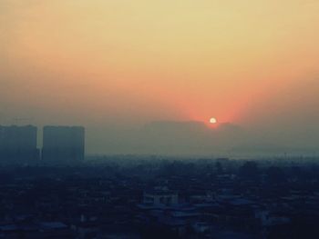 Cityscape against sky during sunset