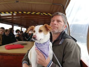 Thoughtful man with dog in ferry